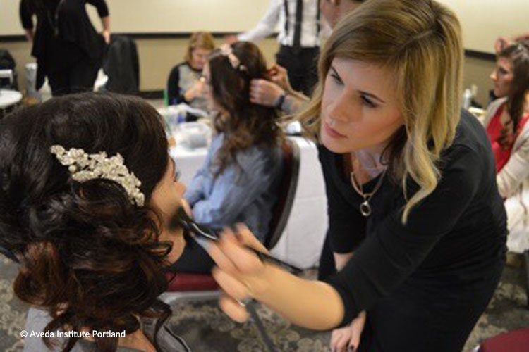 image of a student working hair and makeup during an event