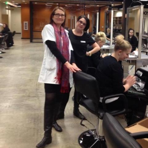 Instructor Lisa Westom Aveda Institute Portland instructor on the salon floor at the Vancouver campus