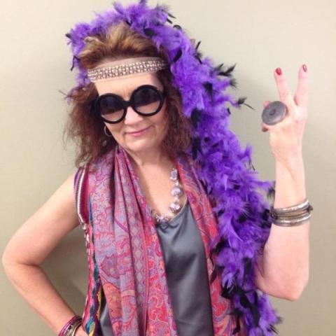 Instructor Lisa Westom Aveda Institute Portland Instructor dressed up with big sunglasses and a purple feather boa.